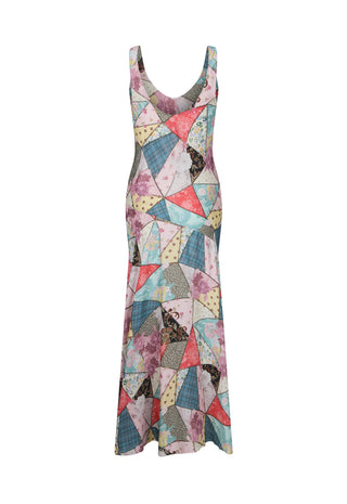 a-sleeveless-scoop-neck-maxi-dress-featuring-a-colorful-geometric-patchwork-print-with-triangles-and-irregular-shapes-in-pink-blue-yellow-and-gray-shown-against-a-plain-white-background